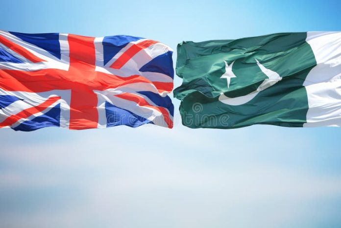 British Pakistan Flags Amid Blue Skies Uk Pakistan Flags 163655179