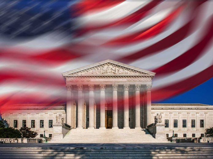 Usa Washington D C Supreme Court Building And Blurred American Flag Against Blue Sky