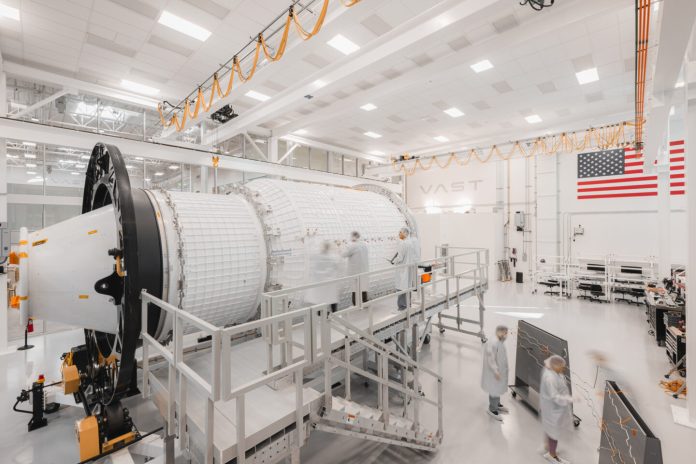 Haven-1 commercial space station assembly in progress, showing engineers and modules in a high-tech facility